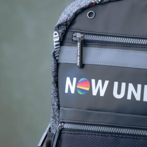 Detailed view of Now United branded backpack showcasing colorful design.
