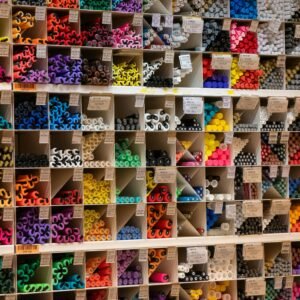 Vibrant array of art supplies neatly organized in shelves, offering a rainbow of colors and textures.